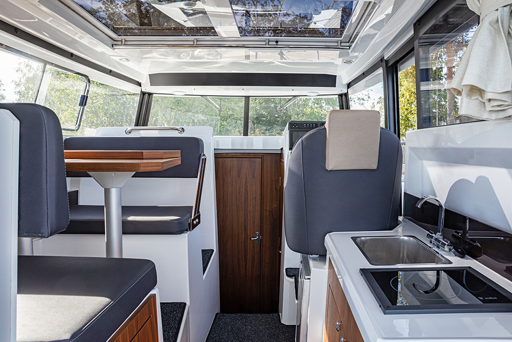 Enclosed wheelhouse to the Finnmaster Pilothouse 8 showing dinette and galley