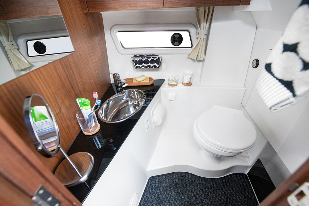 Heads compartment of the Finnmaster P8 showing loo, sink and wood finish.