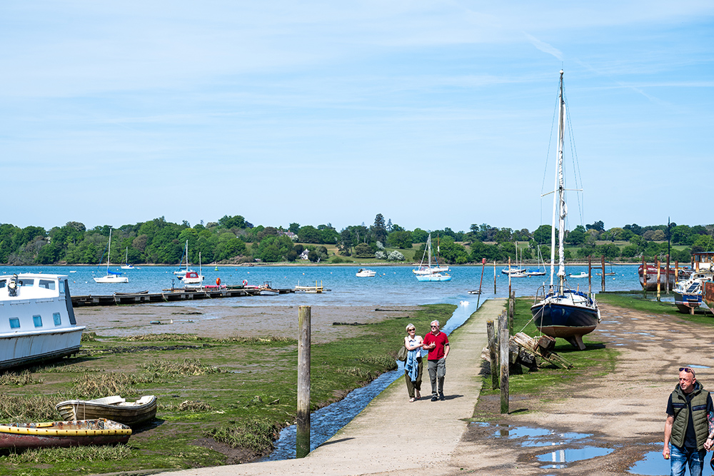 Pontoon walkway with couple walking up away from the boats