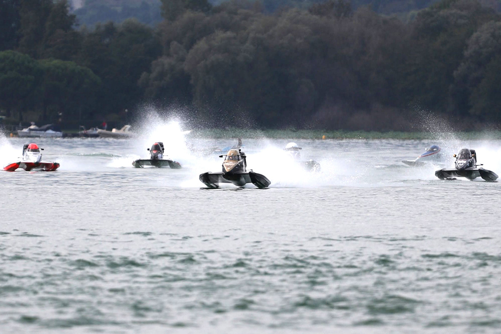 UIM F4 World Championship powerboats race across Viverone, throwing up spray as the fleet accelerates.