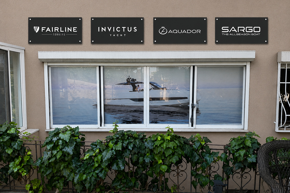 SoleMarin Yachting office with Fairline, Invictus, Aquador and Sargo signs above yacht window graphics.