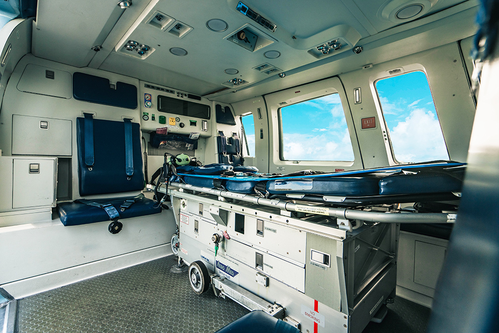 Air ambulance cabin with stretcher and medical equipment for emergency patient evacuation in the Bahamas.