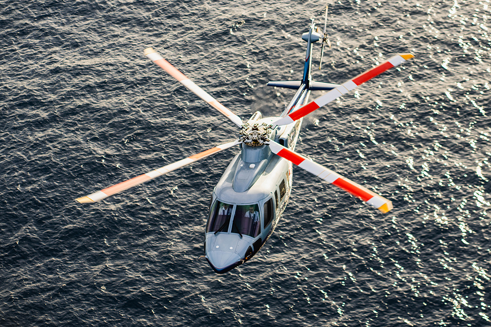 Tropic Air Rescue helicopter flying over open water during a Bahamas emergency medical response mission.