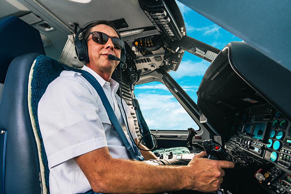 Tropic Air Rescue pilot at the controls of a helicopter during a Bahamas air ambulance flight.
