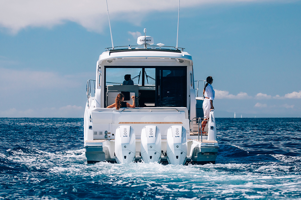 Three white Mercury outboard engines to the stern of a Beneteau Antares 12 motorcruiser