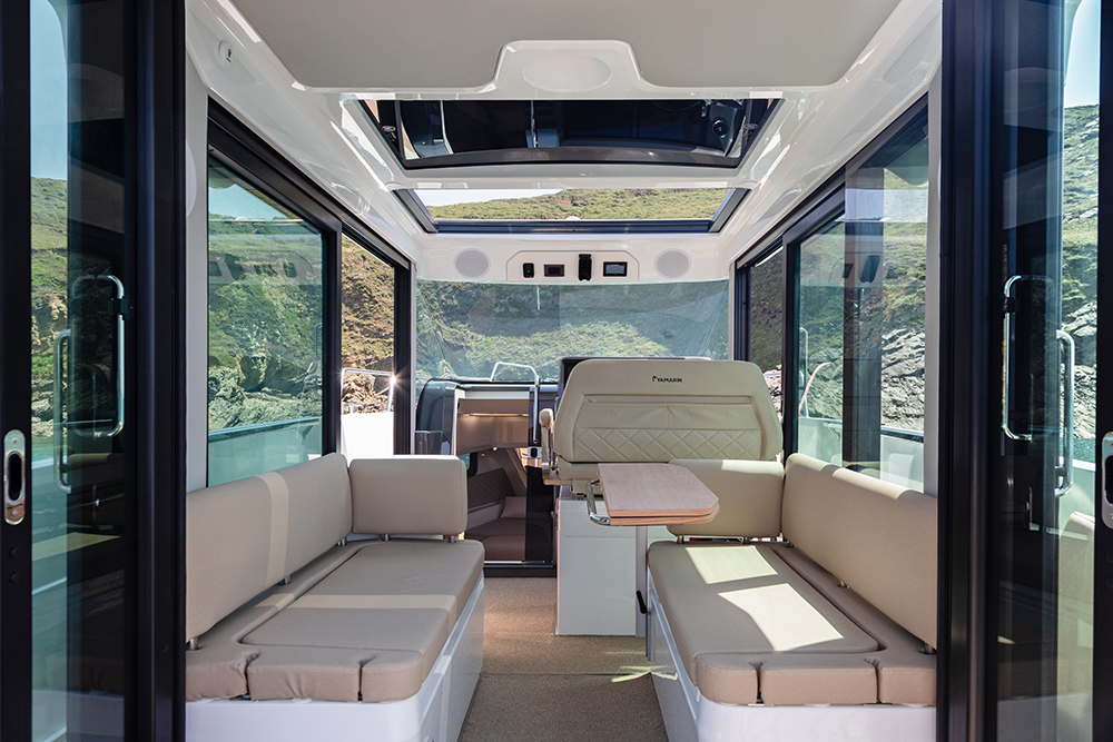 Looking through open double aft doors through to main saloon with full glass windows throughout and the skylight.