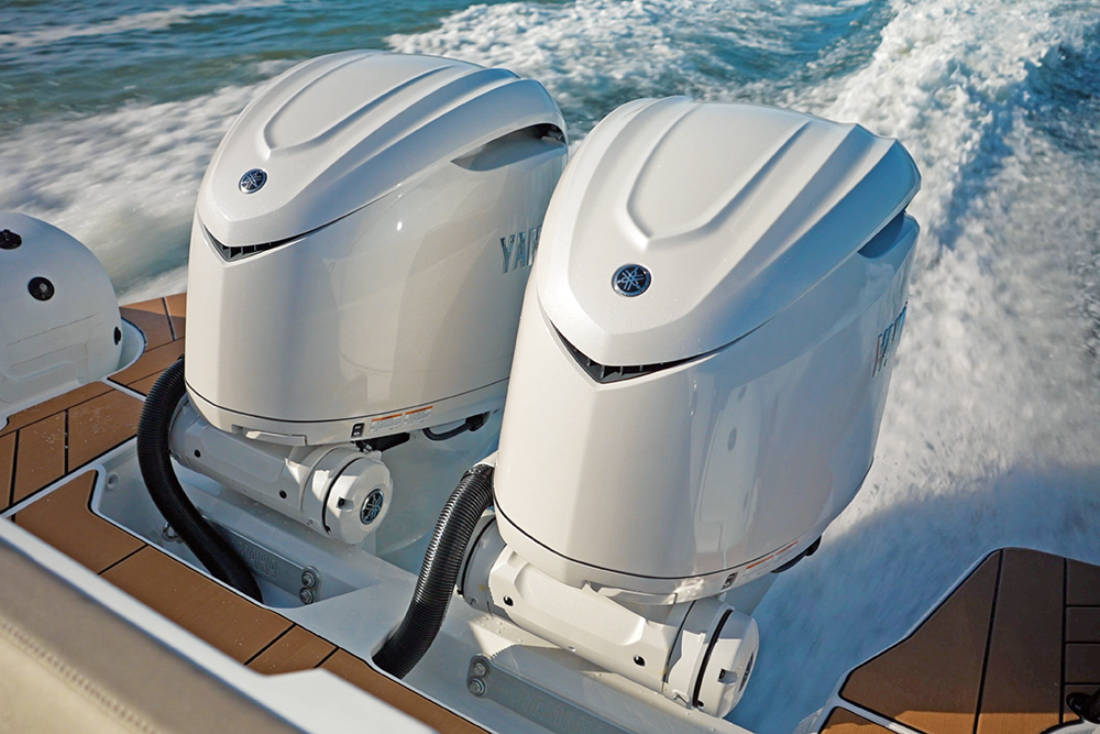 Two white outboard engines, Yamahas, fitted to a RIB transom with teak decking surrounding