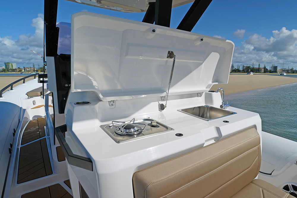 A boat console console showing wet bar with gas powered galley