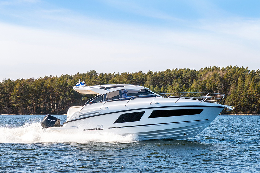 Grandezza 34 Outboard powered by twin Mercury outboards, running fast along Finland's tree-lined coastline.