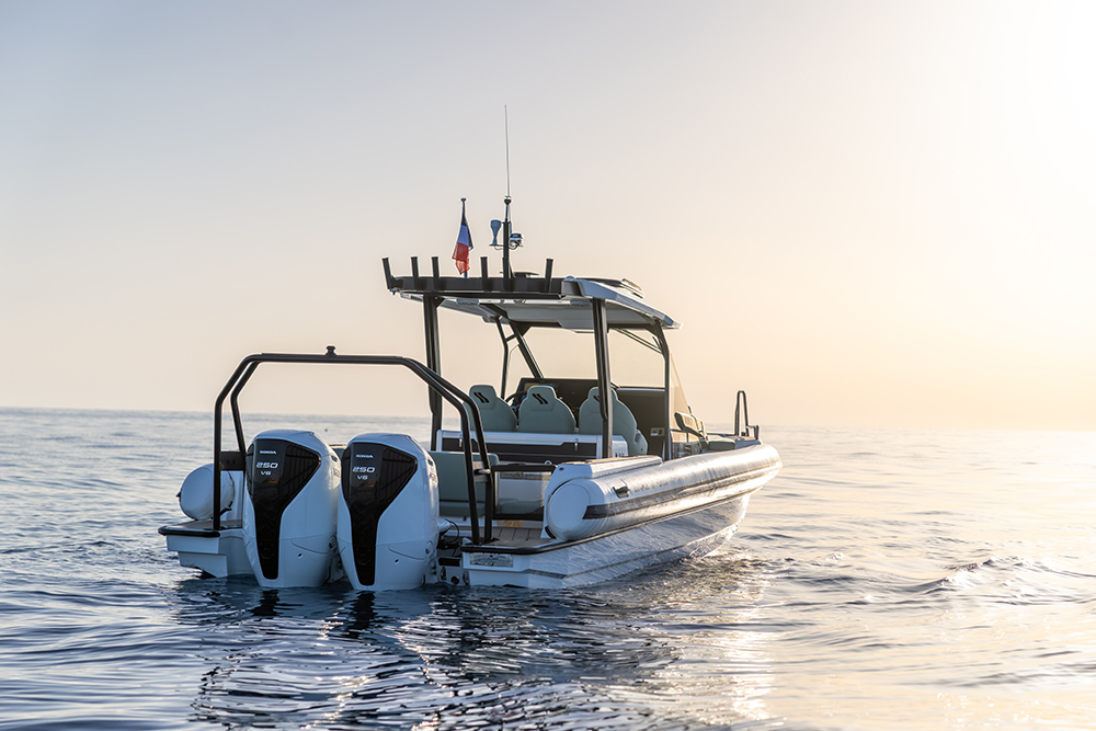 Highfield ADV9 RIB with twin Honda outboards cruising at sunset on calm open water