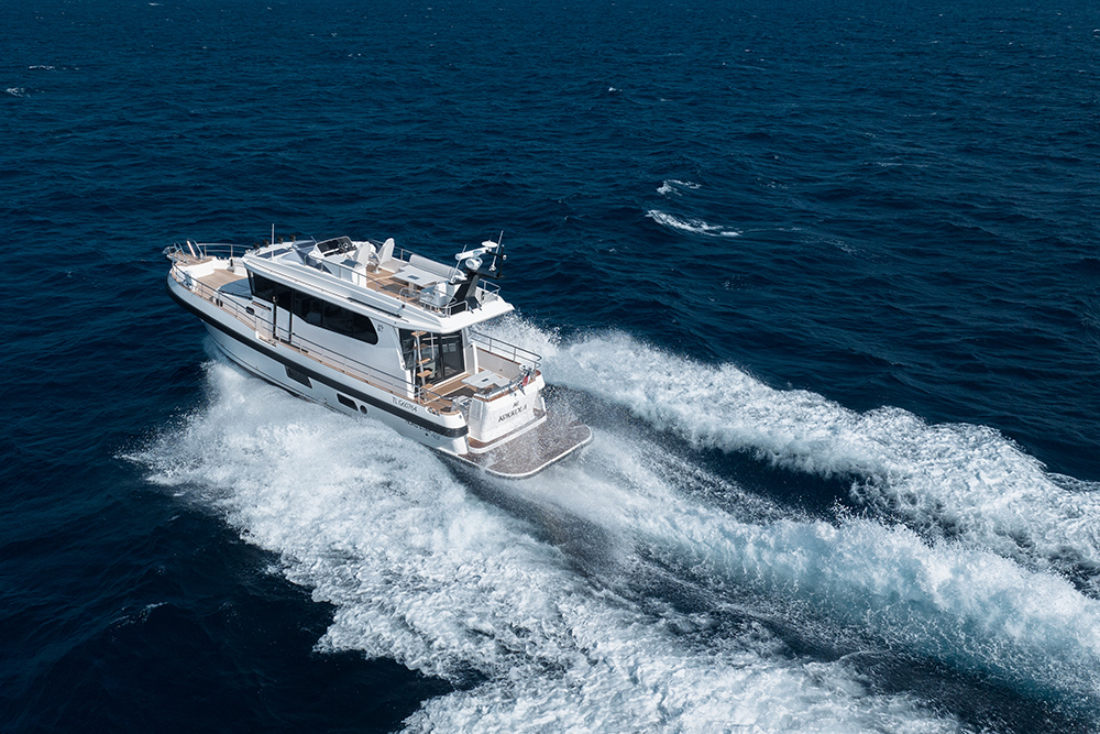 Nord Star 49+SCY Flybridge motor yacht underway at speed on open water, leaving a broad wake