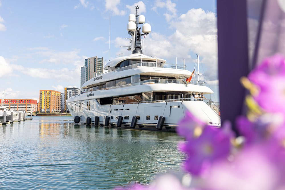 Superyacht Lunasea moored at Ocean Village Marina, Southampton, with waterfront apartments visible behind her.