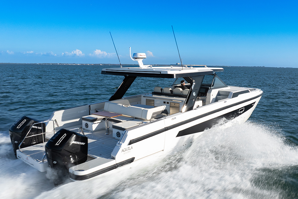 Aquila 45 sport underway with stern view of black Mercury outboard