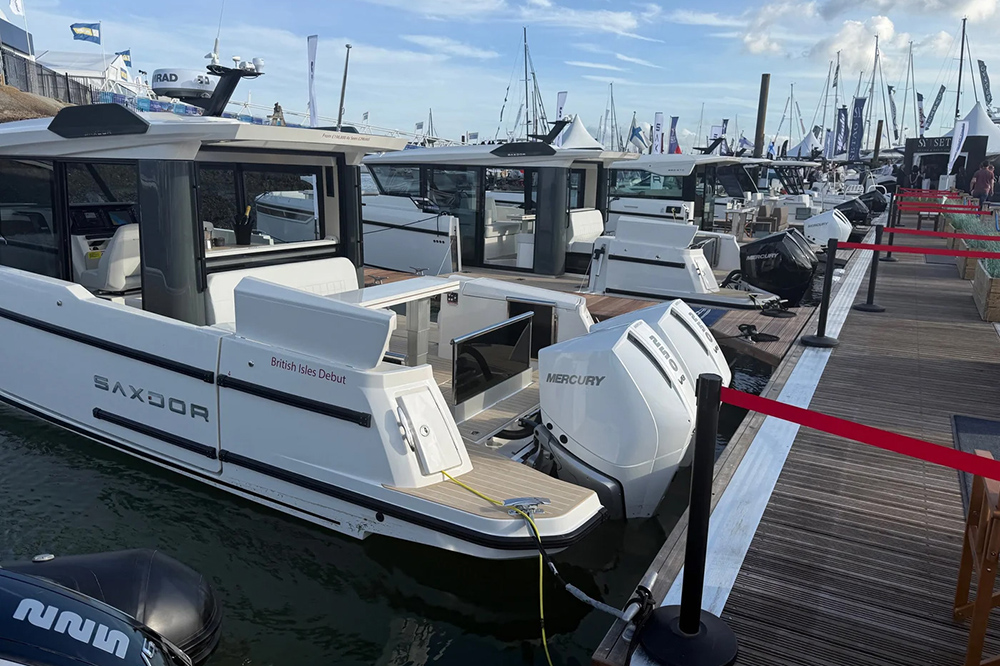 Saxdor boat with twin Mercury outboards moored on a marina pontoon at Southampton International Boat Show