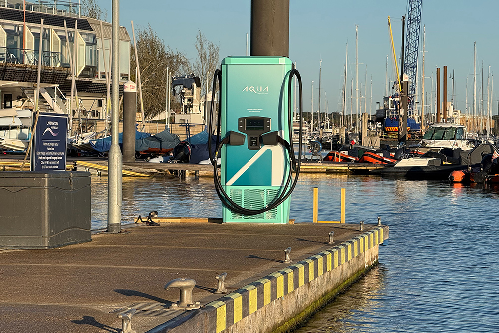 Aqua superPower Aqua 75 electric boat fast charger on a pontoon at Lymington Harbour, with moored boats behind