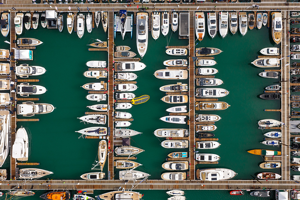 Aerial view of motor yachts and sailing boats moored along the pontoons at Southampton
