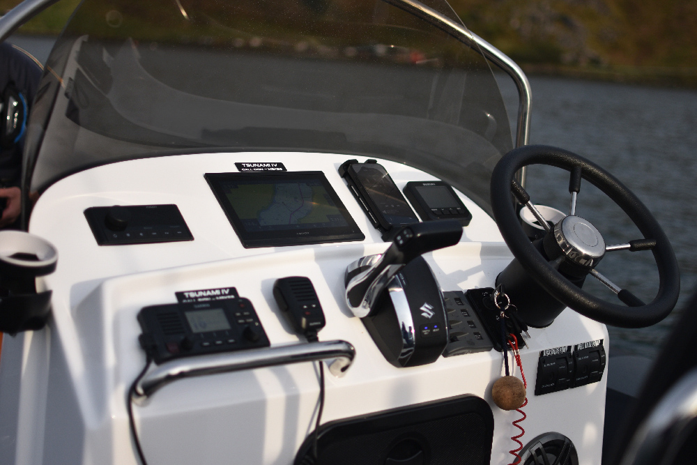 Close-up of the Redbay SF750 console with Garmin VHF, stereo controls, glovebox locker and steering wheel
